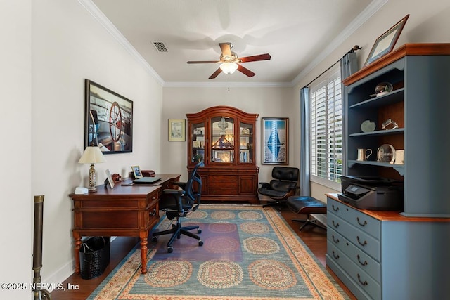 home office with visible vents, ornamental molding, ceiling fan, wood finished floors, and baseboards