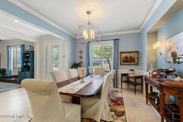 dining room with crown molding, an inviting chandelier, and light tile patterned floors