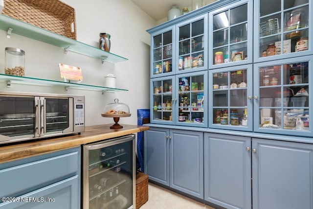 bar with wine cooler and stainless steel microwave