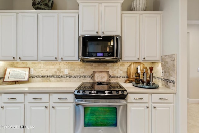 kitchen featuring stainless steel appliances, light countertops, and white cabinetry