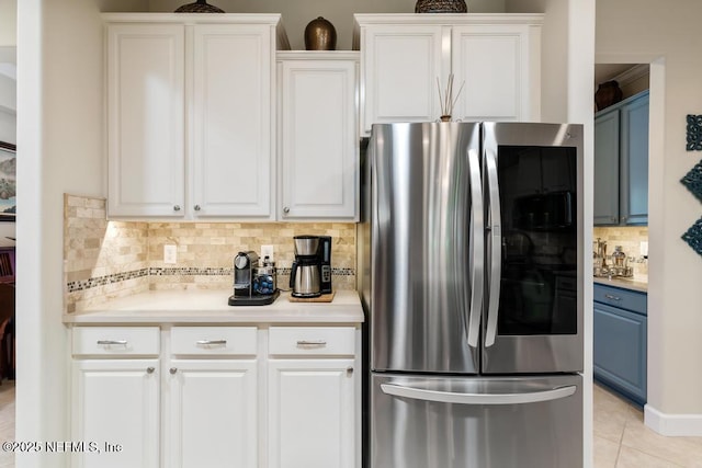 kitchen featuring light tile patterned floors, blue cabinetry, smart refrigerator, and white cabinetry