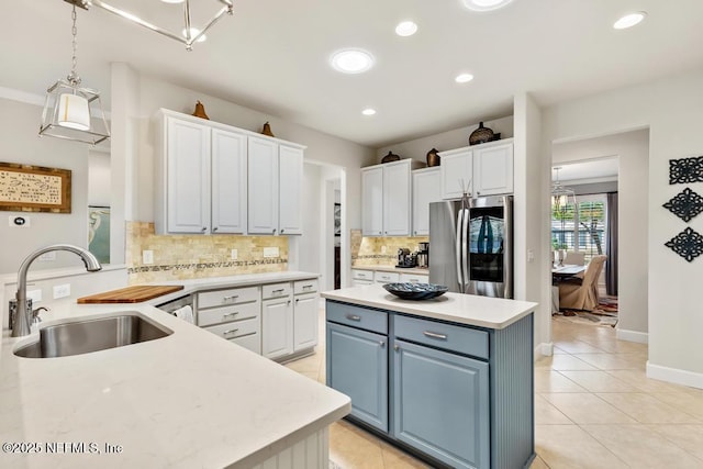 kitchen featuring a kitchen island, a sink, white cabinets, light countertops, and smart refrigerator