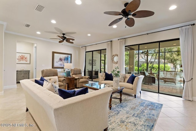 living room with light tile patterned floors, visible vents, and ornamental molding