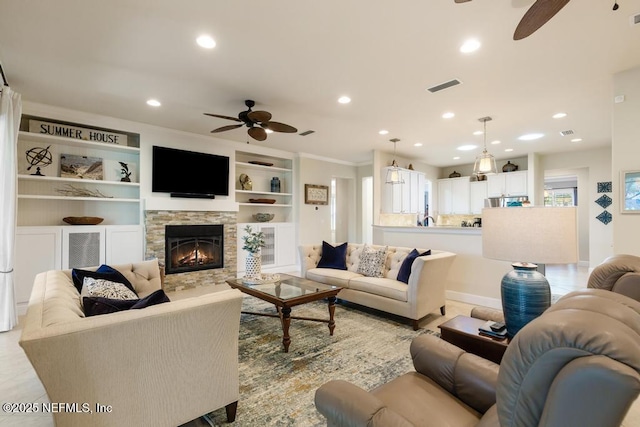 living room with light tile patterned floors, ceiling fan, recessed lighting, a fireplace, and visible vents