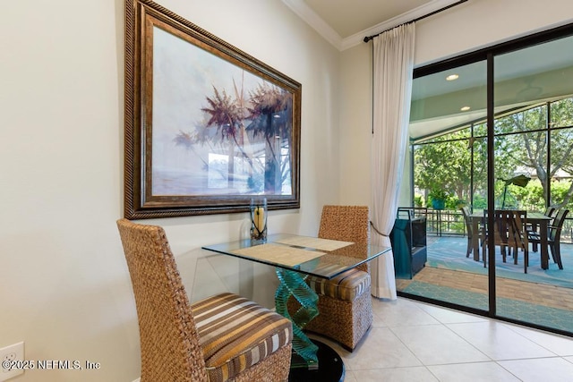 dining area with ornamental molding, plenty of natural light, and light tile patterned floors