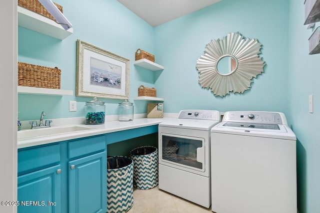 laundry room with washing machine and dryer, light tile patterned flooring, a sink, and cabinet space