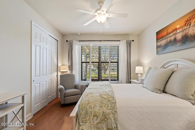 bedroom featuring a ceiling fan, a closet, and wood finished floors