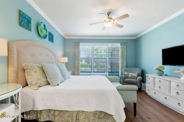 bedroom with a ceiling fan, crown molding, and wood finished floors