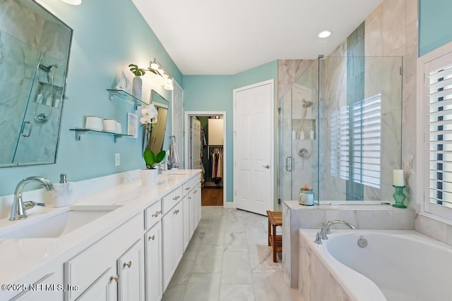 bathroom featuring a sink, marble finish floor, a shower stall, a bath, and double vanity