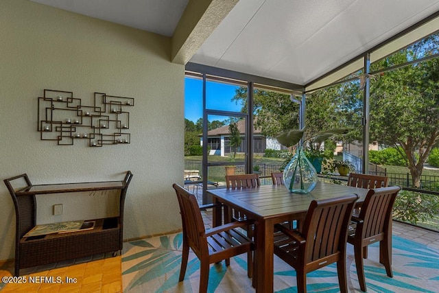 sunroom featuring lofted ceiling