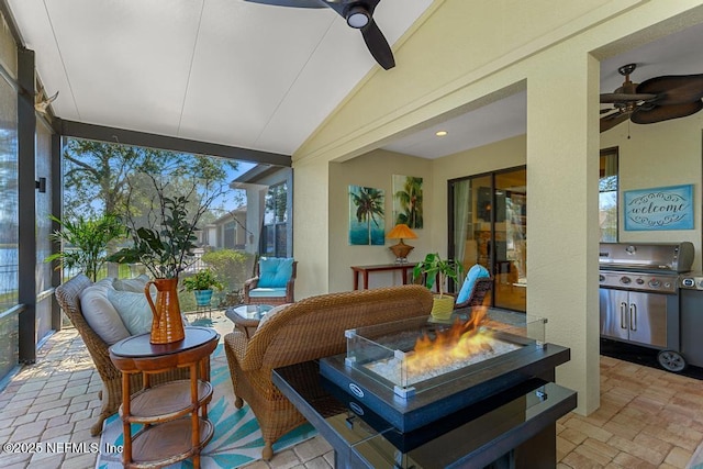 sunroom featuring vaulted ceiling and ceiling fan