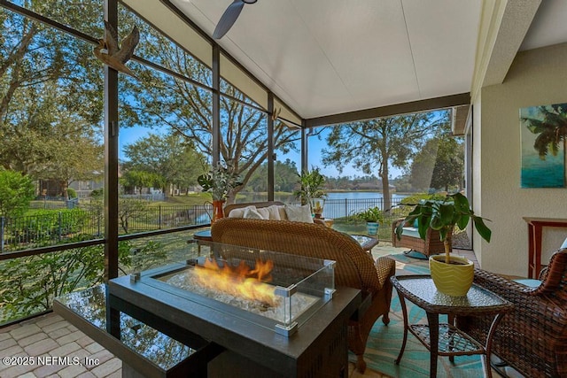 sunroom with a water view and lofted ceiling