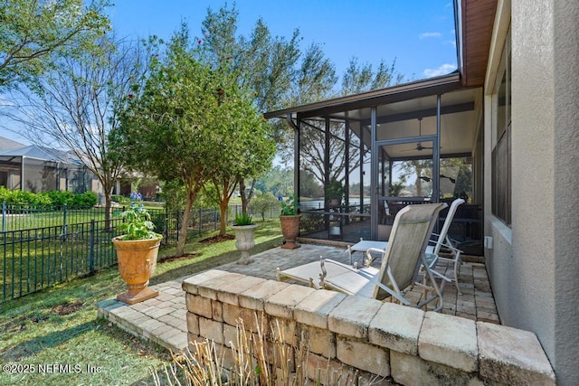 view of patio featuring a fenced backyard and a sunroom