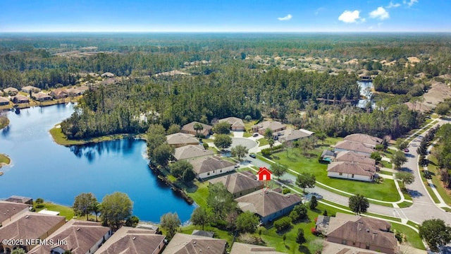 drone / aerial view with a water view, a forest view, and a residential view