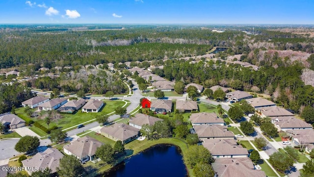 birds eye view of property with a water view and a residential view