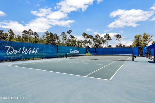 view of sport court featuring fence