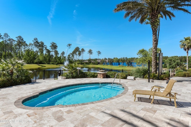 view of pool with a water view, a patio, and fence