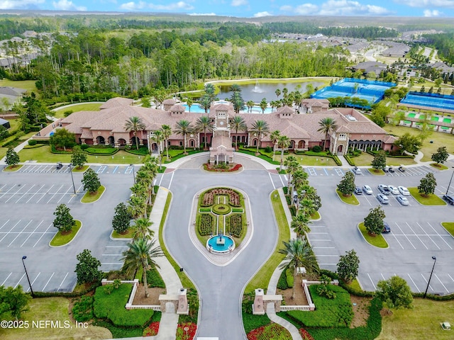 aerial view featuring a water view and a view of trees