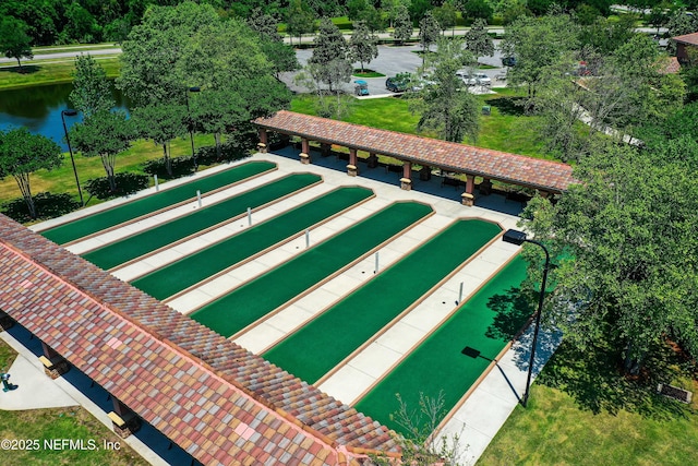 view of home's community featuring a lawn and a water view