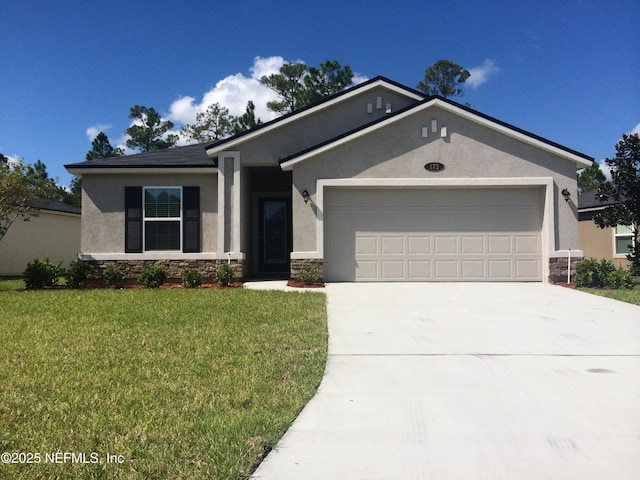 view of front of home with stucco siding, stone siding, a garage, and a front lawn