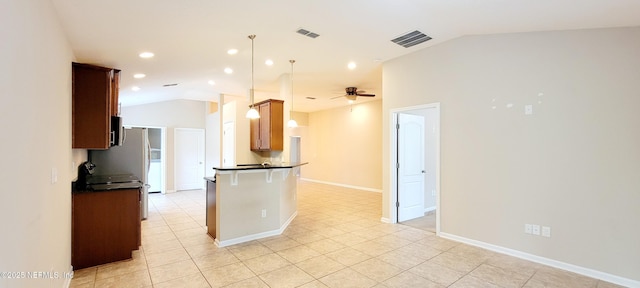 kitchen featuring dark countertops, visible vents, and lofted ceiling