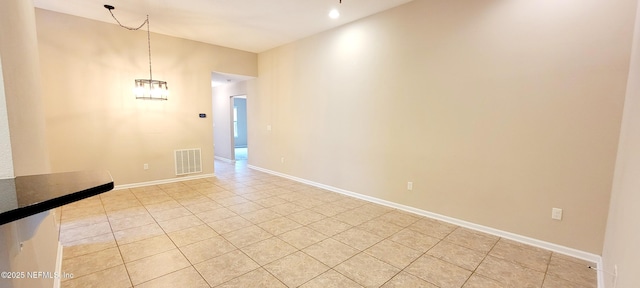 unfurnished room featuring light tile patterned floors, baseboards, and visible vents