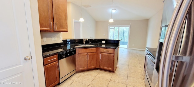 kitchen featuring a sink, a peninsula, brown cabinetry, and stainless steel appliances