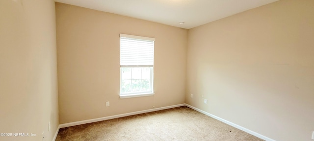 carpeted empty room with baseboards