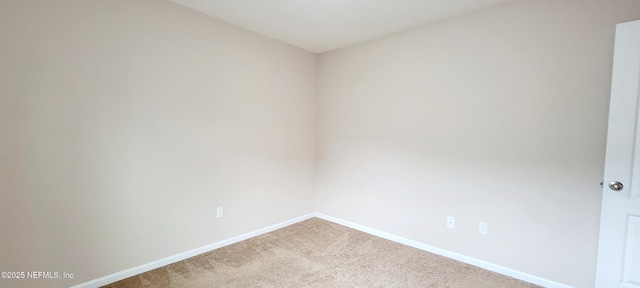 spare room with baseboards and carpet