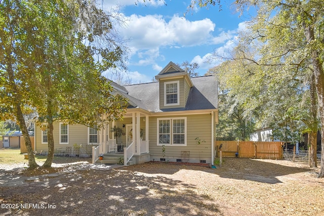 view of front of property with fence, roof with shingles, and crawl space