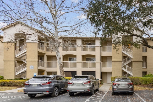 view of building exterior with uncovered parking