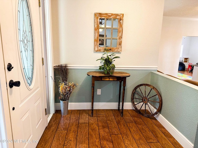 foyer featuring crown molding and hardwood / wood-style floors