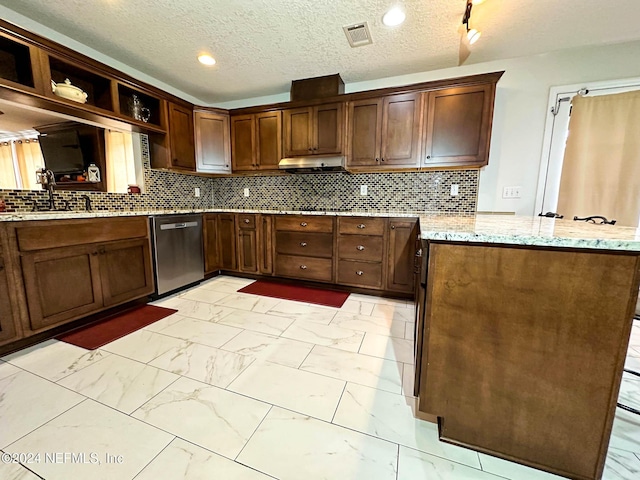 kitchen featuring kitchen peninsula, stainless steel dishwasher, tasteful backsplash, and light stone countertops