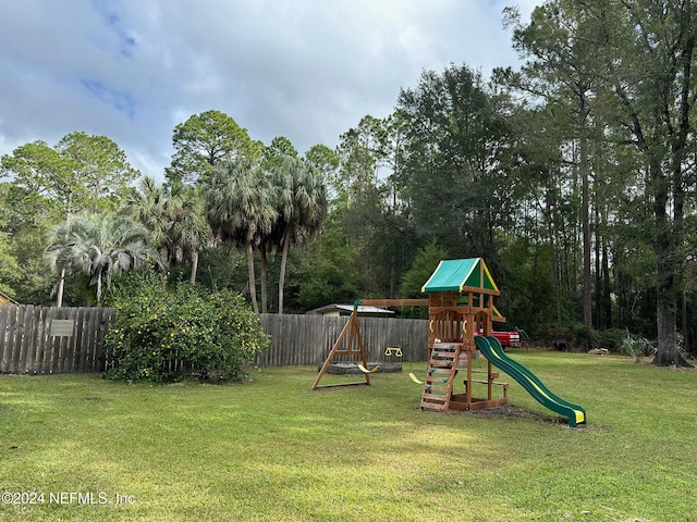 view of playground with a lawn