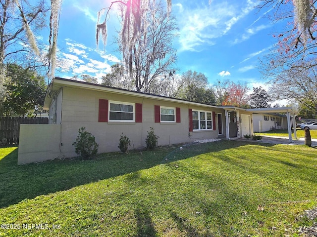 single story home with a front lawn and a carport