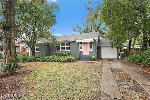 single story home featuring a front lawn and a garage