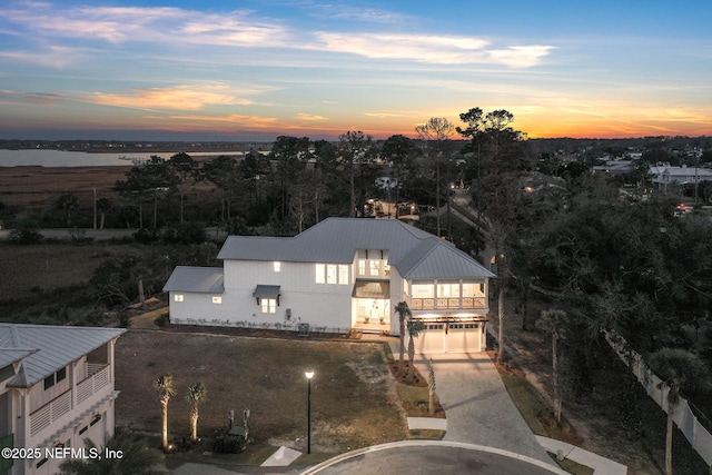 exterior space featuring concrete driveway and metal roof