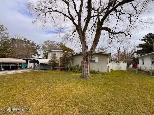 exterior space with a yard and a carport