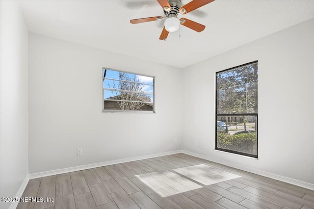 unfurnished room with ceiling fan and plenty of natural light