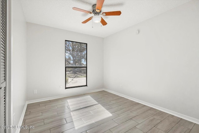 spare room with ceiling fan and a textured ceiling