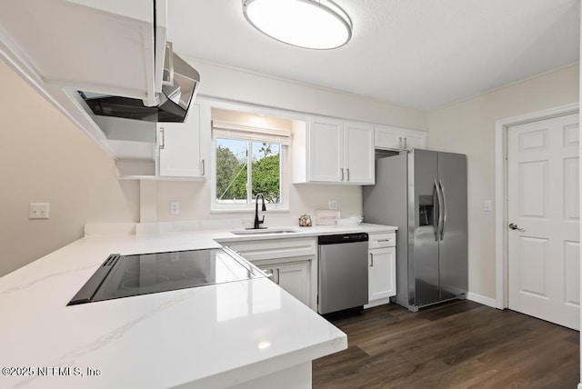 kitchen with appliances with stainless steel finishes, sink, white cabinetry, dark hardwood / wood-style flooring, and light stone countertops