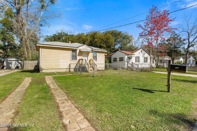 bungalow-style home with driveway, a front yard, and fence