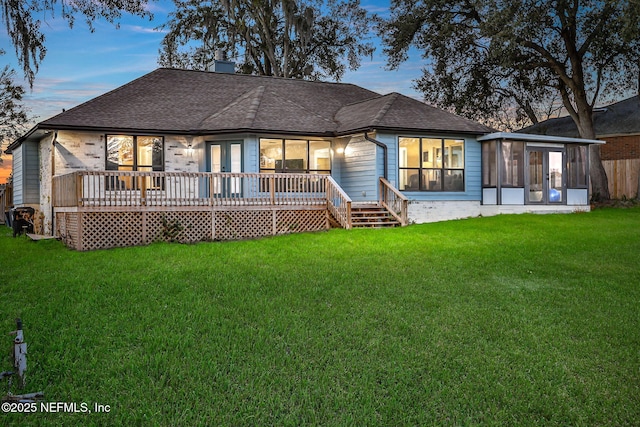 994 Lakeridge Dr, Orange Park, FL 32065 - back of house featuring a sunroom, a deck, a lawn, and roof with shingles