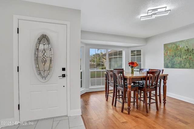 994 Lakeridge Dr, Orange Park, FL 32065 - dining space featuring light wood-type flooring, baseboards, and a textured ceiling