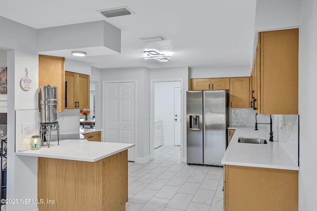 994 Lakeridge Dr, Orange Park, FL 32065 - kitchen with stainless steel fridge, visible vents, a peninsula, light countertops, and a sink