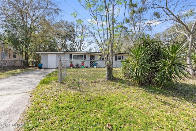 view of front of house with a front lawn, stucco siding, fence, and aphalt driveway