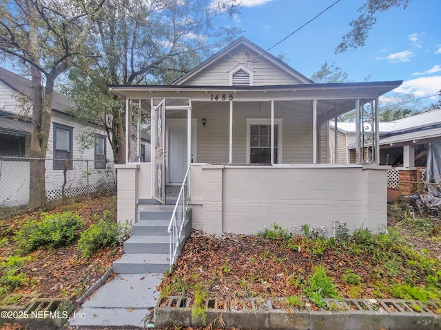 view of front of house with a porch and fence