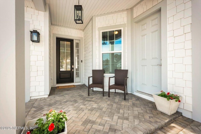 view of exterior entry with covered porch