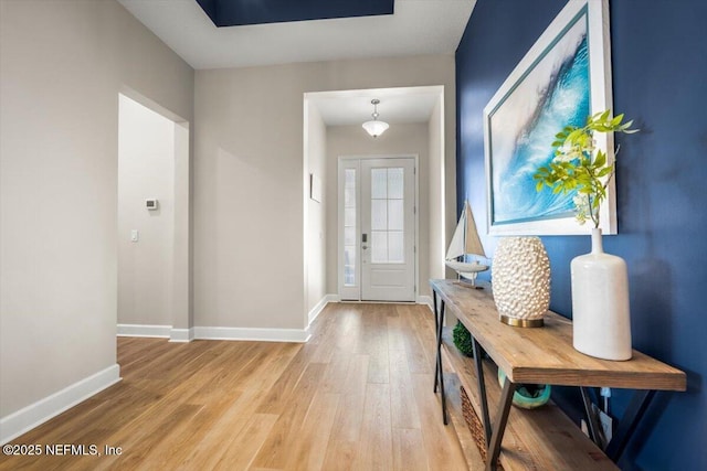 interior space with light wood finished floors and baseboards