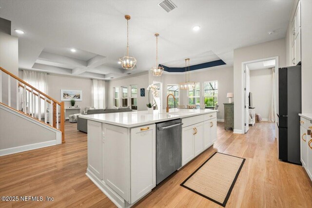 kitchen with visible vents, freestanding refrigerator, stainless steel dishwasher, white cabinetry, and a notable chandelier